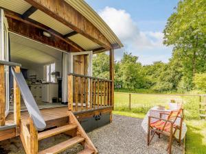 a tiny house with a porch and a table at 1 Bed in Narberth 88421 in Jeffreston