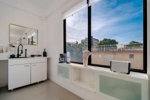 a white bathroom with a large window with a view at Luma Boutique Collection by PH in San Juan +142 photos