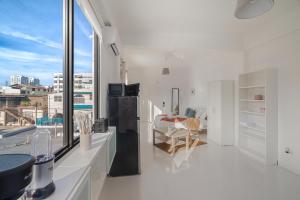 a white kitchen with a view of a city at Luma Boutique Collection by PH in San Juan