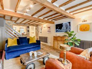a living room with a blue couch and a table at 2 Bed in Hay-on-Wye 93221 in Hay-on-Wye