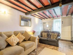 a living room with a couch and two chairs at 2 Bed in Bacton 88326 in Bacton