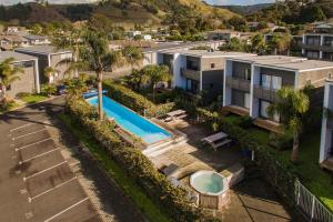 an aerial view of a house with a swimming pool at Sea Views at 7 - Beachside Apartment in Whitianga