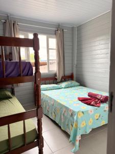 a bedroom with two bunk beds and a window at Da Silva Chalé in São Lídio +55 photos