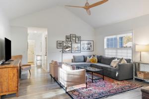 a living room with a couch and a tv at The Clover Cottage in Normaltown in Athens