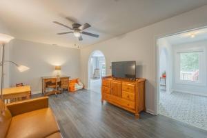 a living room with a couch and a television on a dresser at Restful Riverside Residence w Firepit in Athens