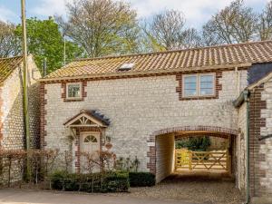 a brick house with a garage in front of it at 3 Bed in Thornham KT104 in Thornham