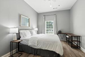 a bedroom with a large bed and a window at NEW LISTING The Classic City Collection - 3 Separate Units in Athens