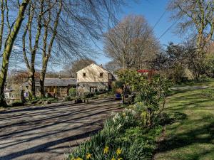a house on a road with trees and flowers at 2 Bed in Tregaron 43293 in Tregaron