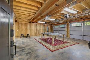 a ping pong table in a room with wooden walls at Milltown Cove Escape on Lake Hartwell in Hartwell