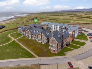 an aerial view of a large house on the beach at 2 Bed in Porthcawl 87294 in Porthcawl