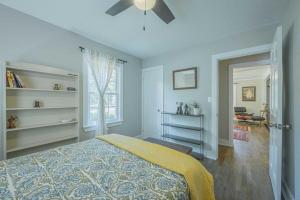 a bedroom with a bed with a yellow blanket at Eclectic Inn Downtown - 2 miles to Sanford Stadium in Athens