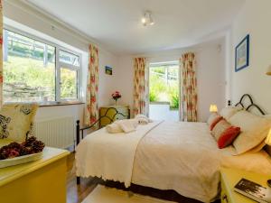 a bedroom with a large bed and a window at 2 Bed in Bridport 88614 in Chideock