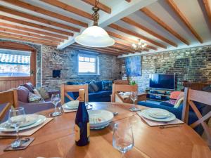 a dining room with a table and a couch at 2 bed in Hunmanby 52376 in Hunmanby