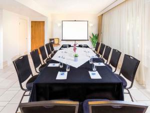 a conference room with a long table and chairs at The Sebel Noosa in Noosa Heads +129 photos