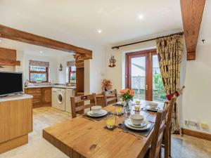 a kitchen and dining room with a wooden table at 2 Bed in Borrowdale 86397 in Rosthwaite