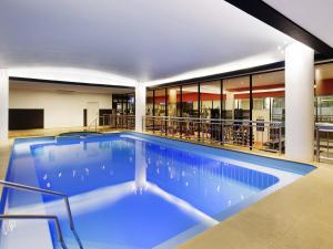 a swimming pool in the middle of a building at Pullman Melbourne Albert Park in Melbourne