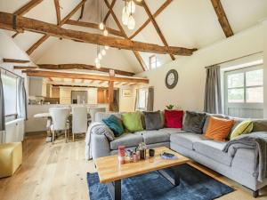 a living room with two couches and a table at 3 Bed in Wroxham 86387 in Swanton Abbot