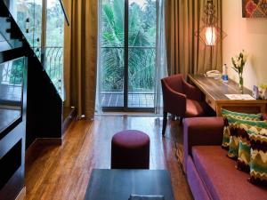 une pièce avec une table et des chaises et une grande fenêtre dans l'établissement Novotel Goa Resort & Spa Candolim, à Candolim 109 autres photos