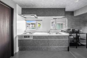a kitchen with a sink and a counter top at The Arklune in Sapporo