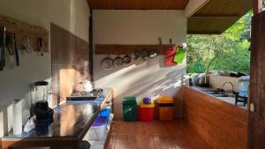 a kitchen with a counter and a sink in a room at Playa Ganadito Ecolodge in Drake