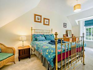 a bedroom with a bed and a chair at 2 Bed in Glen Clova 93001 in Kirriemuir