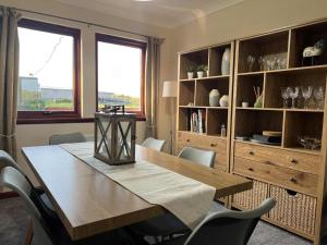 a dining room with a wooden table and chairs at 3 Bed in Port William 87541 in Mochrum