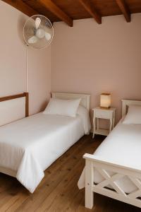 a bedroom with two beds and a fan at La Unión in Mar Azul +5 photos