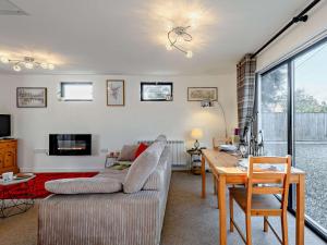 a living room with a couch and a table at 1 Bed in Sturminster Newton TOLDC in Sturminster Newton