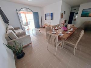 a living room with a table and chairs and a couch at Blue house on blue beach in Pitimbú PB in Pitimbu