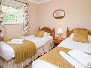 - 2 lits dans une chambre avec un miroir et une fenêtre dans l'établissement 3 Bed in Nr Bamburgh CN084, à Warenford 5 autres photos