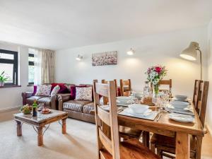 a living room with a table and a couch at 3 Bed in Okehampton TCOAH in Broadwoodwidger