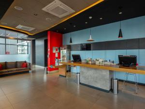 a lobby with a bar with a couch in the background at Ibis Guaratingueta Aparecida - Circuito da Fé in Guaratinguetá