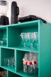 a green shelf with glasses on it at Apartamento Baixu 1 in Prado