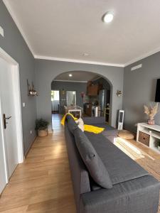 a living room with a gray couch in the middle at Casinha de Galveias in Galveias