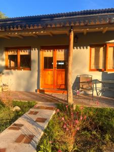 a house with a wooden door and a patio at Ranchos de la Tata in Las Calles