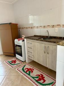 a kitchen with two kitchen rugs on the floor at Apê VistaBella seu refúgio no Caparaó in Alto Caparao