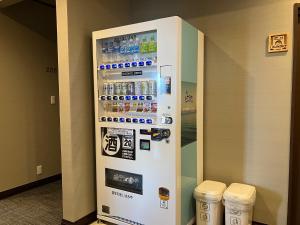 a vending machine with bottles of water and drinks at 遊学の宿いさみや  +13 photos