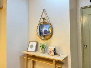 a mirror on a wall next to a table at Modern 2br Unit in Davao in Davao City +2 photos