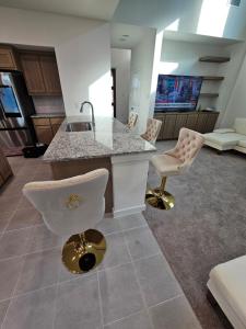 a kitchen with a sink and a counter with chairs at Talia Heaven in Mesquite +39 photos