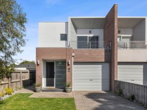 a brick house with two garage doors at Time Out on Flinders in Indented Head