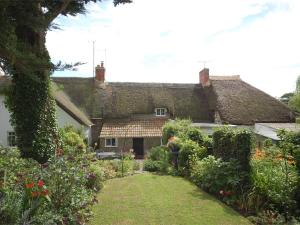 a house with a garden in front of it at 1 Bed in Burton Bradstock DC016 in Burton Bradstock