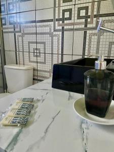 a table with a bottle of soap on a plate at Chalé Recanto dos Pássaros in Gramado +26 photos