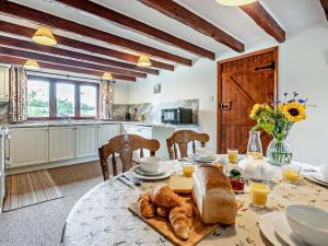 a dining room with a table with bread on it at 4 Bed in Bude LAMER in Merryfield