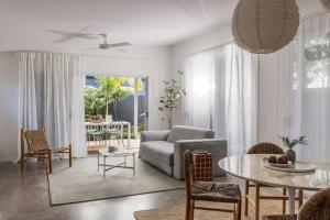 a living room with a couch and a table at The Local House - Byron Bay in Byron Bay