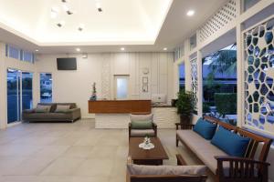 a living room with a couch and a table at Tuana Hotels Brook Pool Access in Chalong 