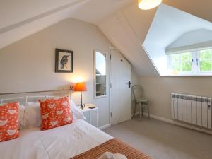 a bedroom with a bed with orange and white pillows at 2 Bed in Kelling 76755 in Kelling