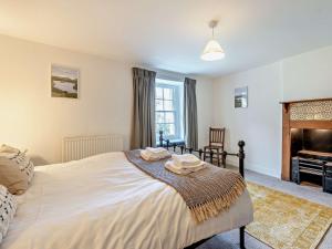 a bedroom with a large bed and a piano at 3 Bed in Braithwaite SZ174 in Braithwaite