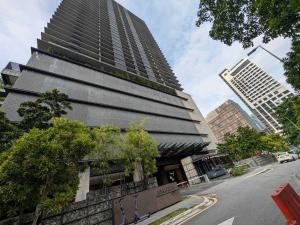 a tall building with a building in a city at Leo Guesthouse in Kuala Lumpur