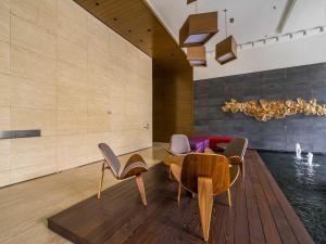 a living room with a table and chairs and a pool at Leo Guesthouse in Kuala Lumpur