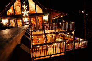 a house with lights on the stairs at night at Wonderland Cabin in Sevierville